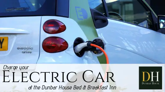 Dunbar House promotional image: Charge your Electric Car at the Dunbar House with image of electric car hooked up to charging station.